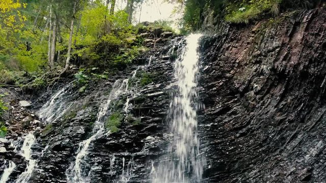 Beautiful autumn waterfall Zhenetskyi Huk in carpathian mountains, Ukraine. Aerial shoot from drone