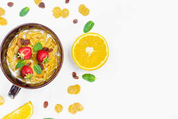 Cereal, morning breakfast, corn flakes, raisins, almonds, mint leaves, orange juice, strawberry, top view, white background, flat lay. The concept of healthy, proper nutrition, ditox.