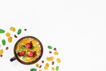 Cereal, morning breakfast, corn flakes, raisins, almonds, mint leaves, strawberry, top view, white background, flat lay. The concept of healthy, proper nutrition, ditox.