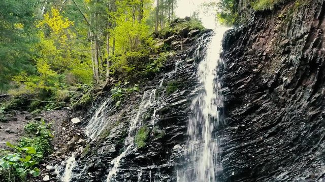 Beautiful autumn waterfall Zhenetskyi Huk in carpathian mountains, Ukraine. Aerial shoot from drone