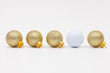 Gold Christmas decoration and white golf ball