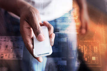 New technology. Close up of a remote control being in hands of a nice young man while watching TV