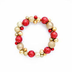 Holiday round frame, pattern made of red and gold glass Christmas balls isolated on a white background. Merry Christmas. The apartment lay, top view