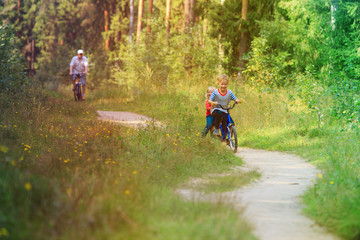 Fototapeta premium active senior with grandkids riding bikes in nature
