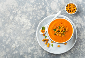 Pureed vegetable soup served with roasred chickpeas, overhead shot