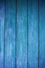 Shabby and very old green-blue wooden fence.