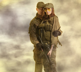 Man and woman in soldier's suit on foggy background