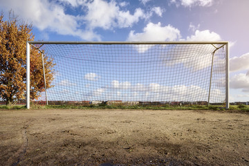 soccer goal with tree, skyline and cloudscape