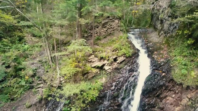 Beautiful autumn waterfall Zhenetskyi Huk in carpathian mountains, Ukraine. Aerial shoot from drone