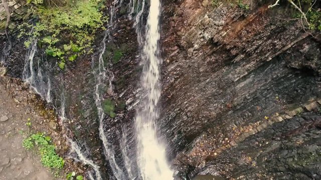 Beautiful autumn waterfall Zhenetskyi Huk in carpathian mountains, Ukraine. Aerial shoot from drone
