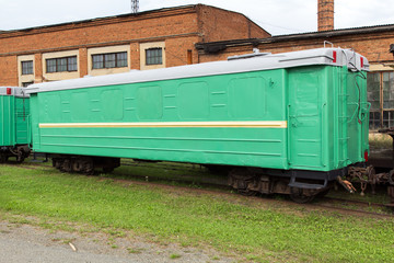 Fototapeta na wymiar Green narrow-gauge railway wagon
