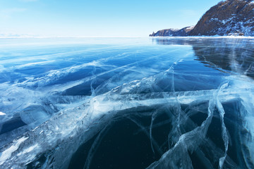 Beautiful texture of blue clear ice on the frozen Baikal Lake