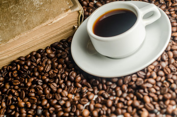 a cup of coffee, grains, books