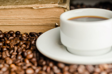 a cup of coffee, grains, books
