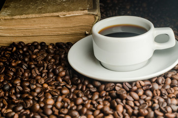 a cup of coffee, grains, books