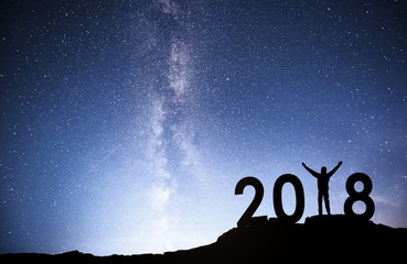 Silhouette young man Happy for 2018 new year background of the Milky Way galaxy on a bright star...