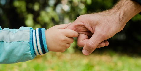 baby hold man's hand