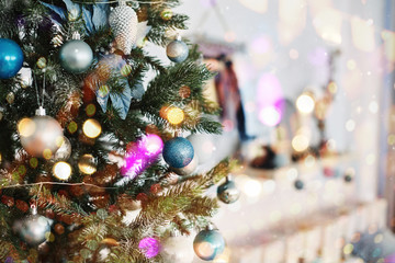 Close up of colorful ornaments on Christmas tree. Happy New Year and Christmas. Bokeh light soft effect