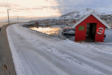 Red fishing hut in the harbor-Lodingsaksla mounts background. Lodingen-Hinnoya-Lofoten-Norway. 0653