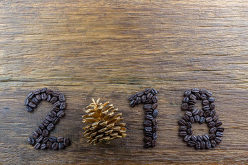 The inscription 2018 made by coffee beans on wood background