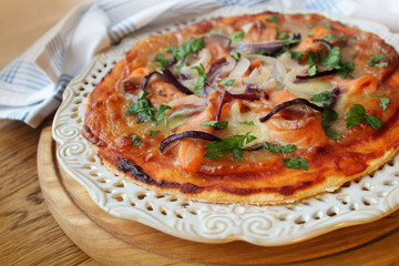 Delicious pizza with salmon and onion