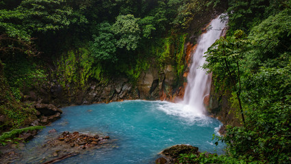 Celestial blue waterfall and pond in volcan tenorio national park