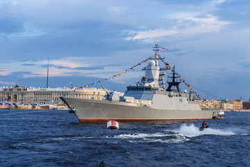 military ship on Neva river in St. Petersburg against the blue sky and the city