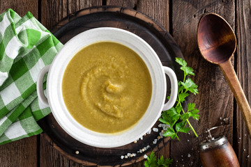 Vegetable cream soup, puree on wooden rustic table, top view