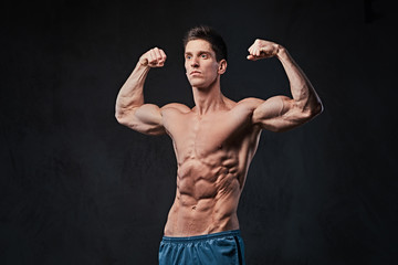Fototapeta na wymiar Shirtless muscular male over dark background.