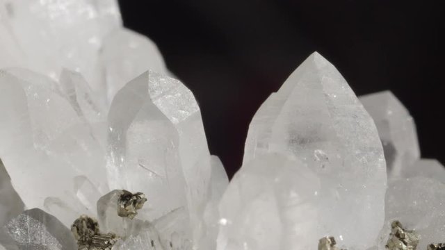 CLOSE UP DOF: Detailed close up of charming opaque white quartz in combination with golden pyrite particles. Shiny gemstones together forming a beautiful sight. Ice like structure of quartz and pyrite