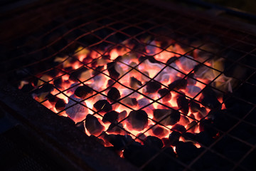 Red hot grill with charcoal ready for BBQ meats at night time