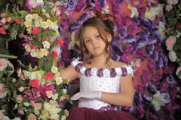 Girl in a purple dress on a floral background
