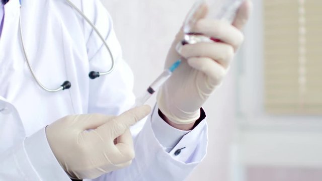 Syringe with a medicine in a hand. 4K UltraHD video