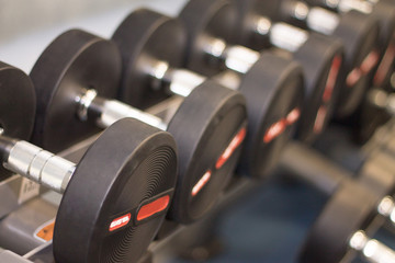 Obraz premium Black hand weights in a gym, close-up