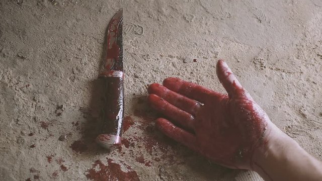 falling hand with a knife and blood. killing concept