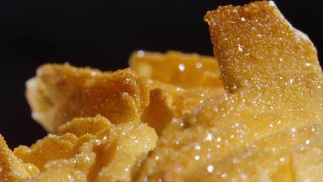 CLOSE UP DOF: Sparkling golden semi precious barite vanadinite stone from Morocco. Precious brown hued rock glimmering with gold undertones. Detailed shot of rough golden precious barite vanadinite.