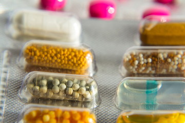 Colorful pills in transparent medicine capsule, nanotechnology future medicine concept