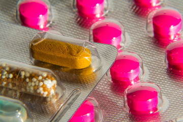 Colorful pills in transparent medicine capsule, nanotechnology future medicine concept