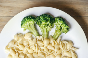 cabbage broccoli with pasta on a white plate