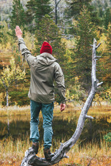 Man traveler in forest landscape Travel lifestyle adventure concept survival into the wild vacations
