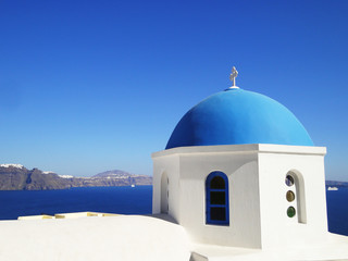 Fototapeta na wymiar Blue dome church frequently seen in Santorini Greece