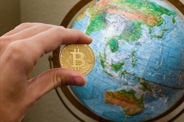 Fototapeta premium Bitcoin and the economy of the world concept coin bitcoin is based on globe world