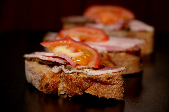 homemade sandwich with bacon and sliced tomatoes