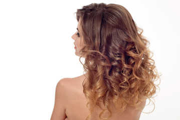 Rear view of female hairstyle with bare shoulders.