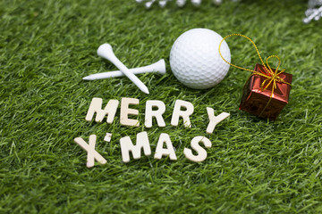 Merry Christmas and Happy New year to golfer on green grass with ornament