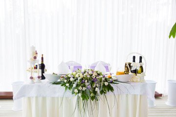 Served table in the restaurant with flower composition