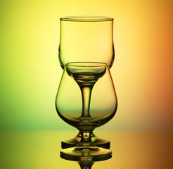 empty glasses on a yellow-green background
