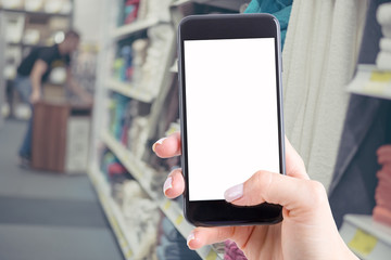 smartphone with a blank screen keeps the woman and shopping in the store