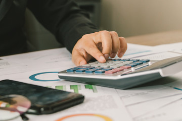 Close up hand of businesswoman accountant or banker using calculator, business finance calculation concept