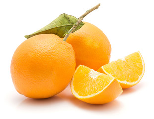 Two oranges and two quarters isolated on white background one with green leaf.